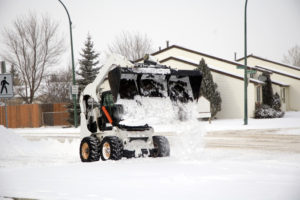 Picture of snow being dumped in Edmonton with a Bobcat bucket.